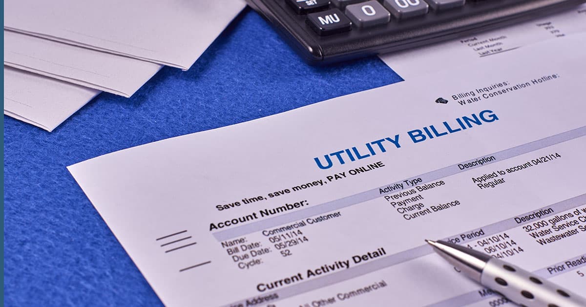 Homeowner comparing utility bill and solar payment documents