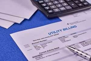 Reviewing Solar Savings Claims and Documents Solar proposal, bills, and calculator on a desk